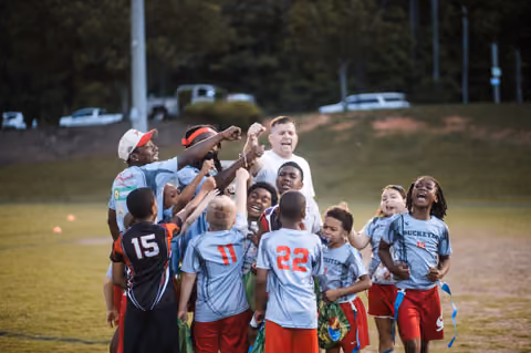 Young football team celebrating a win, photographed by GKeyPhoto